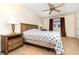 Well-lit bedroom features a ceiling fan, neutral walls, and a comfortable bed with side tables at 4231 Yorketowne Rd, Orlando, FL 32812