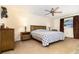 Cozy bedroom featuring a ceiling fan, neutral walls and carpet, and matching wooden furniture at 4231 Yorketowne Rd, Orlando, FL 32812
