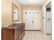 Inviting foyer with tile flooring, modern console table, and large double doors at 4231 Yorketowne Rd, Orlando, FL 32812