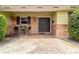 Charming front porch with brick accents, a seating area, and a double-door entrance at 4231 Yorketowne Rd, Orlando, FL 32812