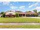 Charming single-story home with mature landscaping and well-maintained lawn at 4231 Yorketowne Rd, Orlando, FL 32812
