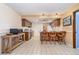 Spacious kitchen with bar seating, wood cabinets, tile floors, stainless steel appliances, and overhead lighting at 4231 Yorketowne Rd, Orlando, FL 32812