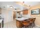Bright kitchen with an island, wood cabinets, tiled floors, and pendant lighting above the breakfast bar at 4231 Yorketowne Rd, Orlando, FL 32812