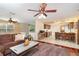 Open-concept living room featuring hardwood flooring and a kitchen with barstool seating in the background at 4231 Yorketowne Rd, Orlando, FL 32812