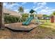 Backyard playground with swings, a slide, and a climbing wall at 4231 Yorketowne Rd, Orlando, FL 32812