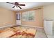 Room featuring a back door, window, painted brick accent, and patterned area rug at 4231 Yorketowne Rd, Orlando, FL 32812