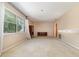Spacious room with carpet, neutral walls, large window, and a vintage cabinet for storage at 4231 Yorketowne Rd, Orlando, FL 32812
