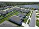 Aerial view showing the community homes with manicured lawns, sidewalks, and neighborhood pond at 4316 Carrabelle River Ln, Lakeland, FL 33811