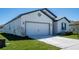 Charming single-story home features a two-car garage, a well-manicured lawn, and a concrete driveway at 4316 Carrabelle River Ln, Lakeland, FL 33811