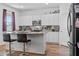 Bright kitchen features white cabinets, granite countertops, stainless steel appliances, and a breakfast bar at 4316 Carrabelle River Ln, Lakeland, FL 33811