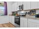 Modern kitchen boasts white cabinets, stainless steel appliances, and stylish countertop space at 4316 Carrabelle River Ln, Lakeland, FL 33811