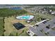 Aerial view showcasing a community pool, playground, parking and surrounding neighborhood at 4316 Carrabelle River Ln, Lakeland, FL 33811
