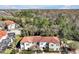 A high angle aerial showing the community's tile roofs and beautiful wooded area at 4500 Alberto Cir, Kissimmee, FL 34746