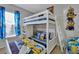 Fun bedroom featuring a white bunk bed with Minion-themed bedding and decor, illuminated by natural light from the window at 4500 Alberto Cir, Kissimmee, FL 34746