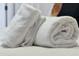 Closeup of plush white towels neatly arranged on a bed in a cozy bedroom setting at 4500 Alberto Cir, Kissimmee, FL 34746
