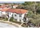 A beautiful home featuring a terracotta roof, manicured lawn, and mature trees at 4500 Alberto Cir, Kissimmee, FL 34746