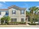 Inviting townhome exterior with manicured landscaping, red tiled roof, and a well-maintained facade at 4500 Alberto Cir, Kissimmee, FL 34746