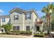 Charming two-story townhome showcasing a red tile roof, neatly trimmed bushes, and welcoming front porch at 4500 Alberto Cir, Kissimmee, FL 34746