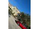 Charming two-story townhome with lush landscaping and a bright red car parked in front at 4500 Alberto Cir, Kissimmee, FL 34746