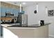 Stylish kitchen with stainless steel appliances and modern pendant lighting above the bar at 4500 Alberto Cir, Kissimmee, FL 34746