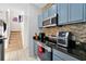 Updated kitchen with stainless steel appliances and a view of the staircase at 4500 Alberto Cir, Kissimmee, FL 34746