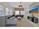 Spacious living room featuring a plush gray sectional sofa, decorative chandelier, and large screen tv at 4500 Alberto Cir, Kissimmee, FL 34746