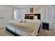 Serene main bedroom featuring a king bed with decorative pillows and a modern black headboard, enhanced by soft lighting at 4500 Alberto Cir, Kissimmee, FL 34746