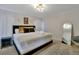 Bright main bedroom featuring a king bed with decorative pillows and modern light fixture, complemented by a stylish mirror at 4500 Alberto Cir, Kissimmee, FL 34746