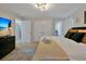 Tranquil main bedroom showcasing a king bed with plush pillows and modern decor, complemented by a large TV at 4500 Alberto Cir, Kissimmee, FL 34746