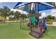 Community playground with a colorful playset and soft turf, creating a safe and fun environment at 4500 Alberto Cir, Kissimmee, FL 34746