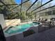 Screened in pool and spa area with lounge chairs and a privacy fence at 4500 Alberto Cir, Kissimmee, FL 34746