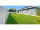 Backyard featuring a fenced in yard with green grass and large tree at 465 Britten Dr, Kissimmee, FL 34758
