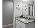 Bathroom with a white vanity, granite countertop, and a decorative mirror at 465 Britten Dr, Kissimmee, FL 34758