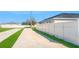 Long driveway with green grass and white fence at 465 Britten Dr, Kissimmee, FL 34758