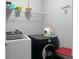 Laundry room with front loading washer and dryer and overhead shelving at 465 Britten Dr, Kissimmee, FL 34758