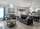 Bright, open-concept living space featuring modern furnishings, chandelier lighting, and sliding door access to the patio at 465 Britten Dr, Kissimmee, FL 34758