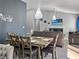 Inviting living room and dining space with modern furnishings, a large television, and modern light fixtures at 465 Britten Dr, Kissimmee, FL 34758