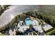 An aerial view shows a pool and lake surrounded by mature trees, with a multi-building structure nearby at 482 Captiva Dr, Davenport, FL 33836