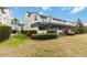 The backyard patio area features a screened-in area and a well manicured lawn at 482 Captiva Dr, Davenport, FL 33836