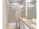 Bathroom featuring a double sink, granite countertops and a walk-in shower at 482 Captiva Dr, Davenport, FL 33836