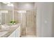 Bathroom with double vanity, granite countertops, and a glass-enclosed shower featuring neutral tile surround at 482 Captiva Dr, Davenport, FL 33836