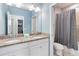 Bathroom with double sink vanity with granite counters and a shower/tub combination with a shower curtain at 482 Captiva Dr, Davenport, FL 33836