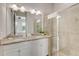 Bathroom featuring a double vanity with granite countertop and a glass-enclosed shower with tile surround at 482 Captiva Dr, Davenport, FL 33836