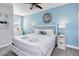 Bright bedroom with a ceiling fan, a window and decoratively designed mirror above the bed's headboard at 482 Captiva Dr, Davenport, FL 33836