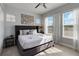 Bright and airy bedroom with a large bed, side table, and natural light from the windows at 482 Captiva Dr, Davenport, FL 33836