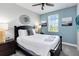 Comfortable bedroom with a decorative mirror, ceiling fan and a window providing natural light at 482 Captiva Dr, Davenport, FL 33836
