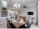 Dining room with chandelier, a view to the kitchen, stairs and living room at 482 Captiva Dr, Davenport, FL 33836
