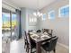 Formal dining room with chandelier, patio access, and view of the pool through the windows at 482 Captiva Dr, Davenport, FL 33836