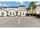 Charming two-story home with a gray front door, white facade, and ample parking at 482 Captiva Dr, Davenport, FL 33836