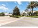 Beautiful community clubhouse with manicured landscaping, palm trees, and ample parking at 482 Captiva Dr, Davenport, FL 33836